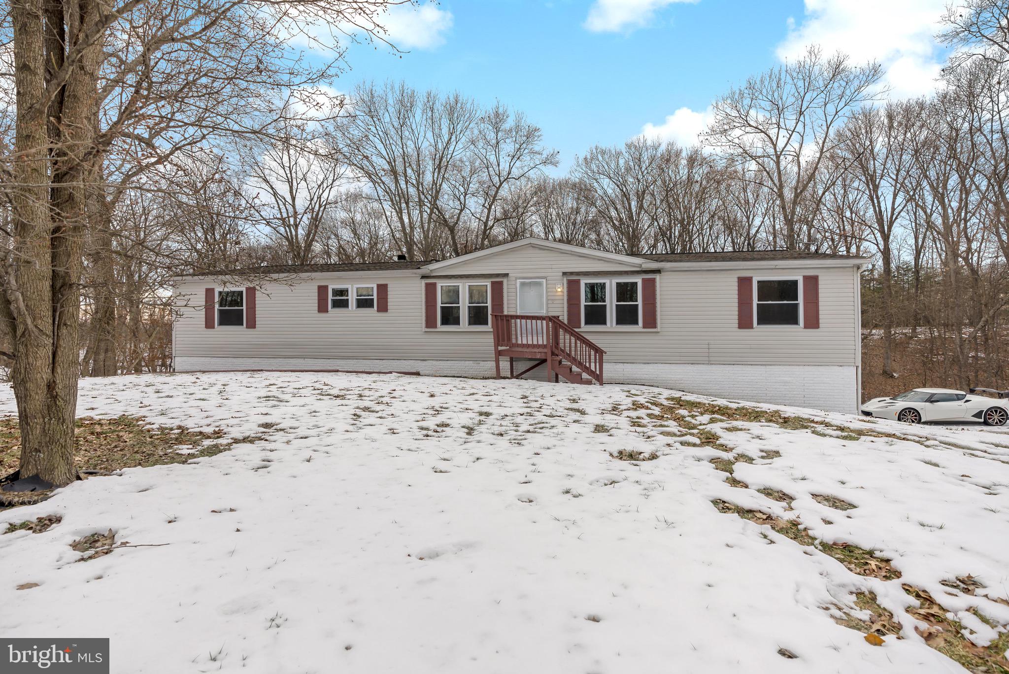 233 Short Road Kearneysville, WV 25430 - Photo 4 of 36 a front view of house with yard and trees around