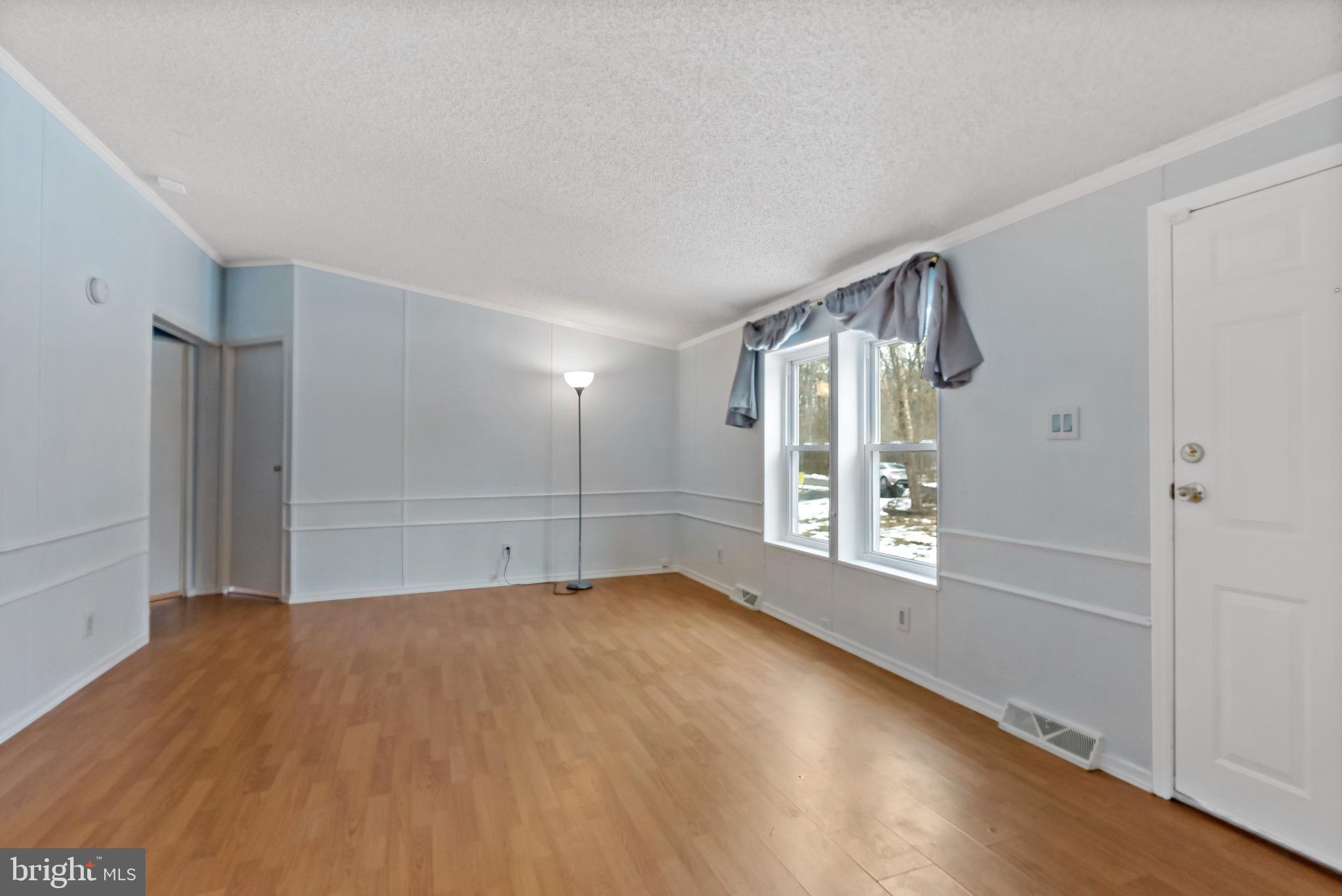 233 Short Road Kearneysville, WV 25430 - Photo 8 of 36 a view of an empty room with a window and wooden floor