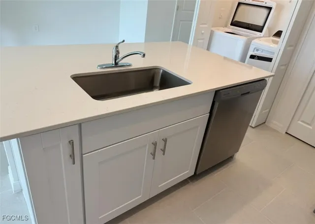 a kitchen with a sink and cabinets
