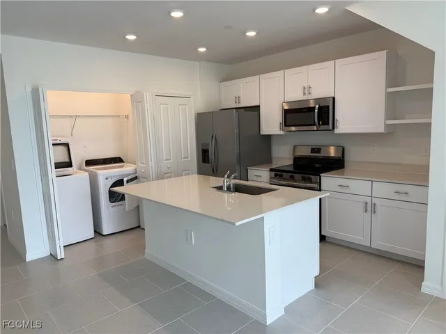 a kitchen with a sink a stove and refrigerator