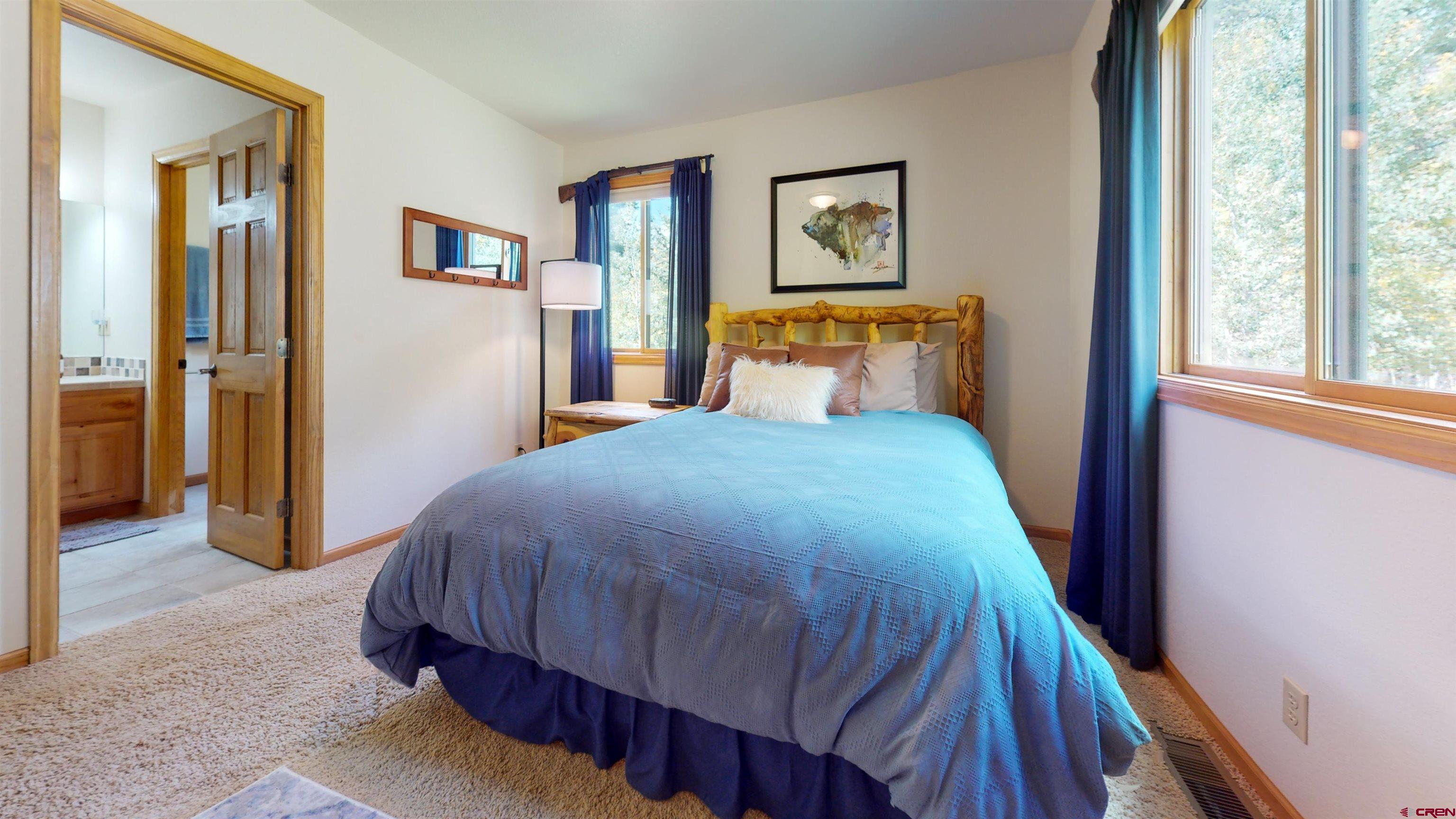 261 Aspen Drive Durango, CO 81301 - Photo 22 of 34 a bedroom with a bed and painting on the wall