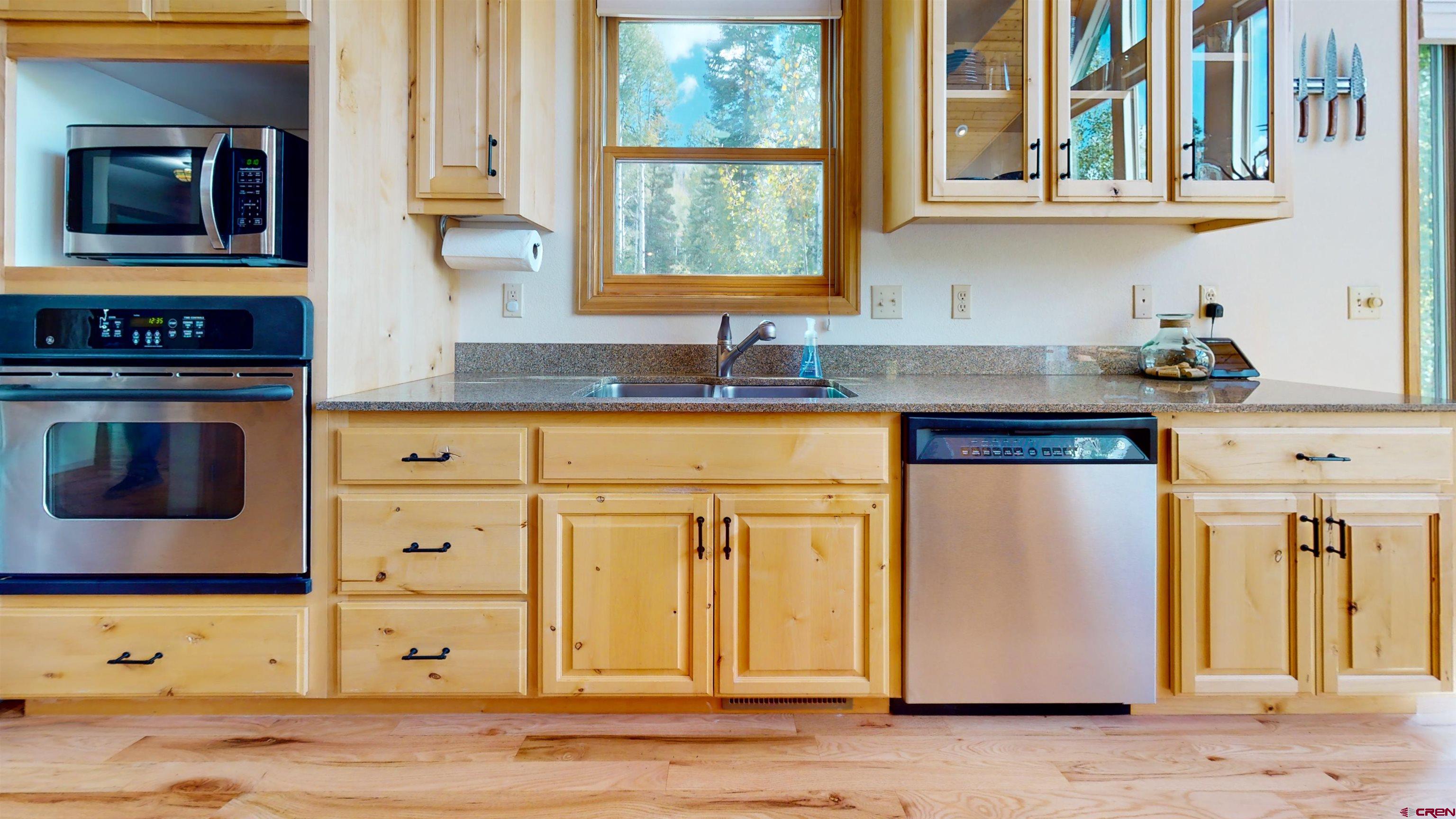 261 Aspen Drive Durango, CO 81301 - Photo 10 of 34 a kitchen with stainless steel appliances granite countertop a stove and a microwave
