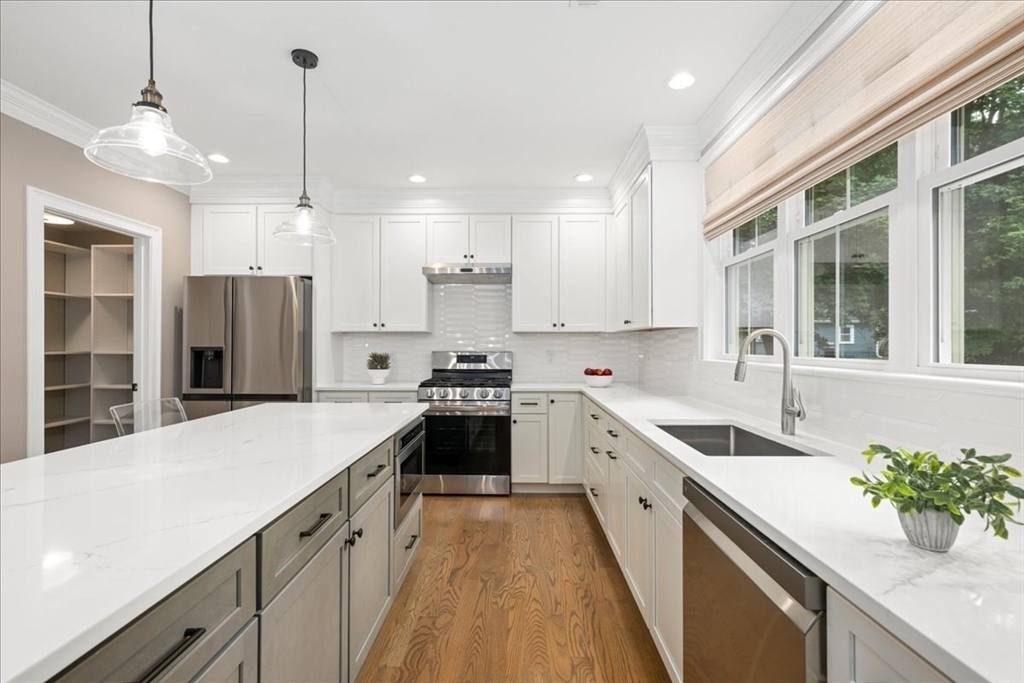11 Waring Road Natick, MA 01760 - Photo 13 of 41 a large kitchen with stainless steel appliances kitchen island a large counter tops and white cabinets