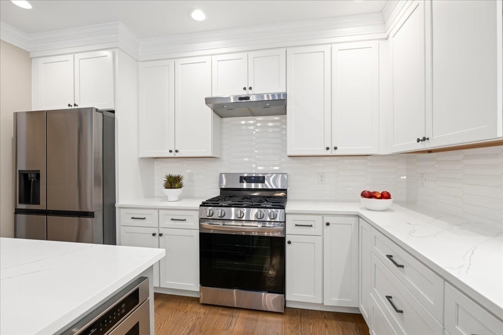 11 Waring Road Natick, MA 01760 - Photo 15 of 41 a kitchen with stainless steel appliances white cabinets and a stove
