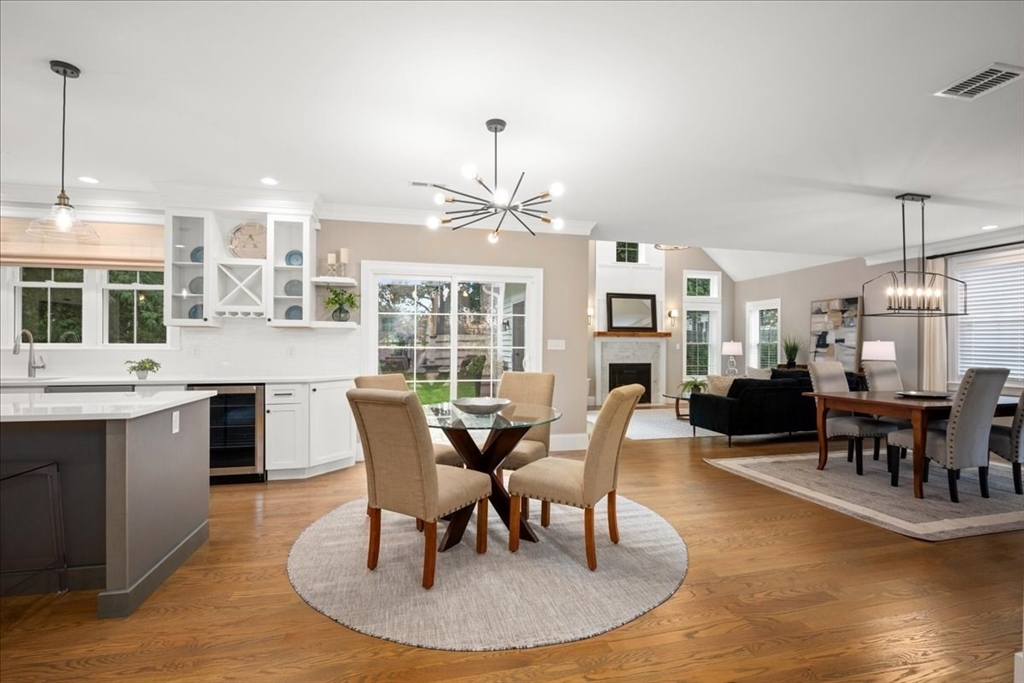11 Waring Road Natick, MA 01760 - Photo 16 of 41 a dining room with wooden floor a chandelier a wooden table and chairs