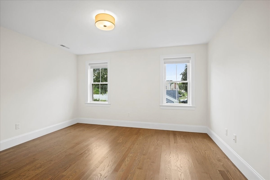 11 Waring Road Natick, MA 01760 - Photo 24 of 41 an empty room with a window and wooden floor