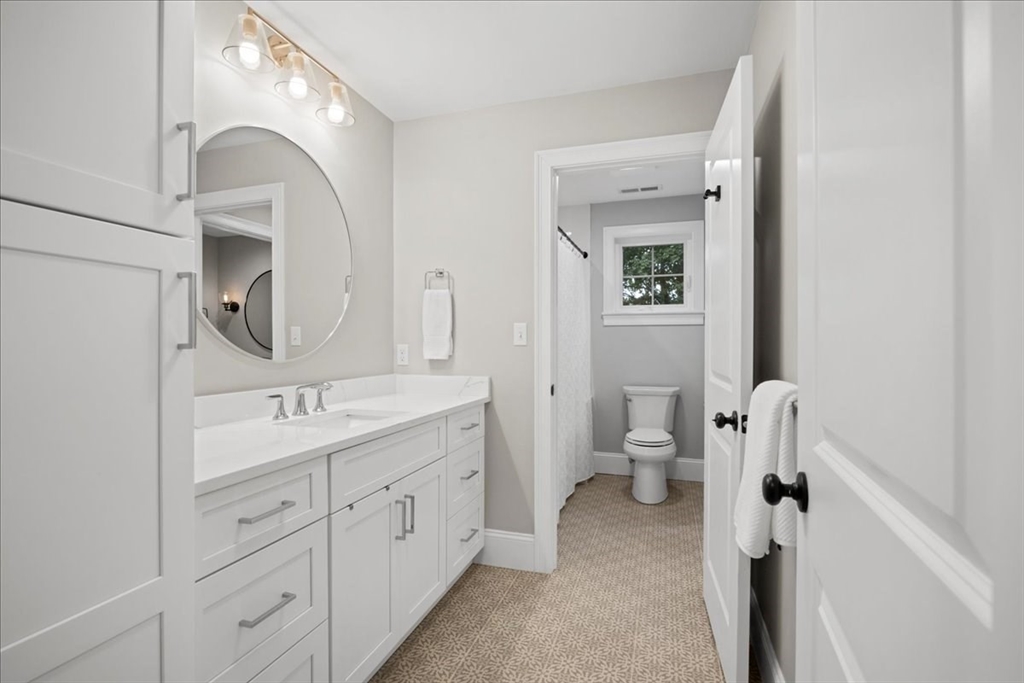 11 Waring Road Natick, MA 01760 - Photo 26 of 41 a spacious bathroom with a toilet sink and mirror