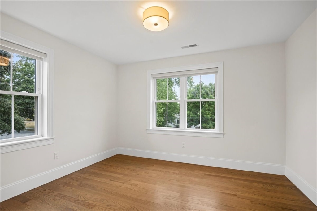 11 Waring Road Natick, MA 01760 - Photo 27 of 41 an empty room with wooden floor and windows