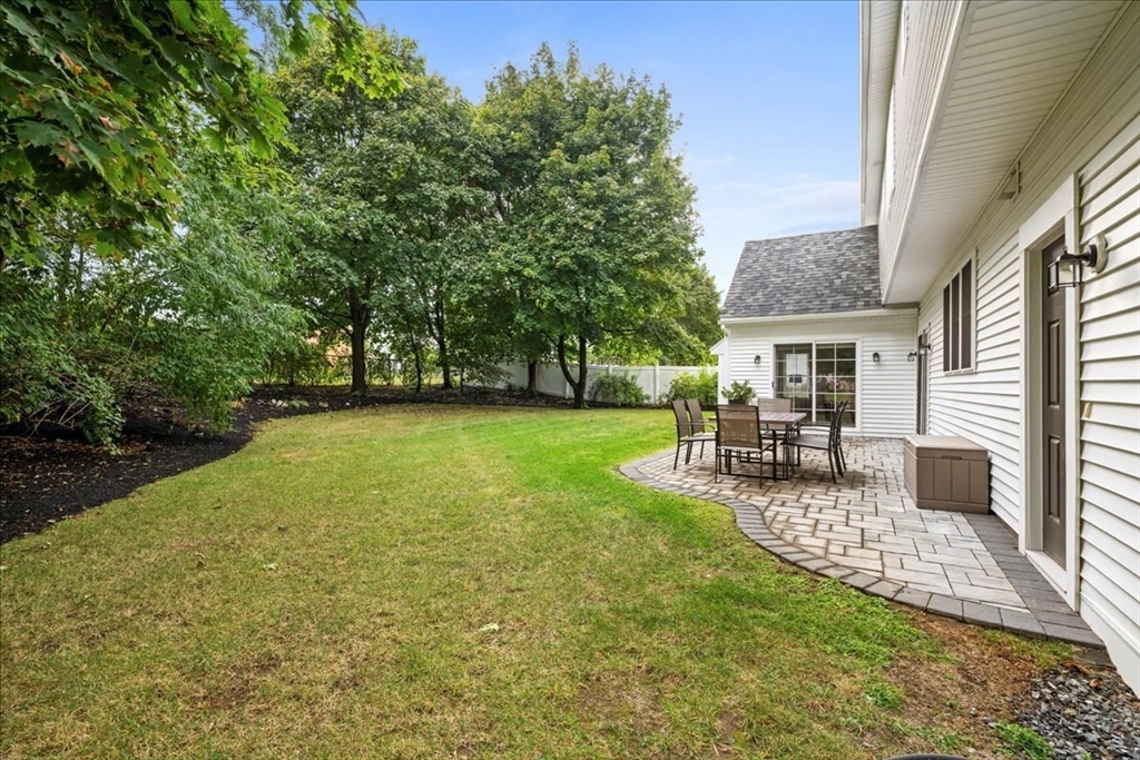 11 Waring Road Natick, MA 01760 - Photo 37 of 41 a view of a patio with table and chairs and potted plants with wooden fence