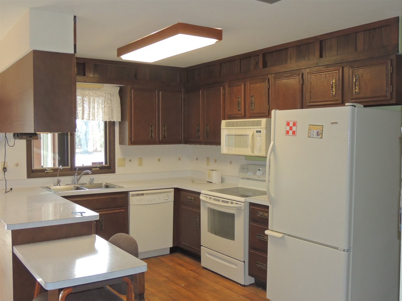 8344 South Schroeder Road Clinton, WI 53525 - Photo 2 of 25 a kitchen with a sink a stove a refrigerator and cabinets