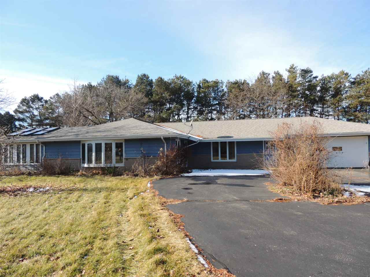 8344 South Schroeder Road Clinton, WI 53525 - Photo 21 of 25 a front view of a house with a yard and garage