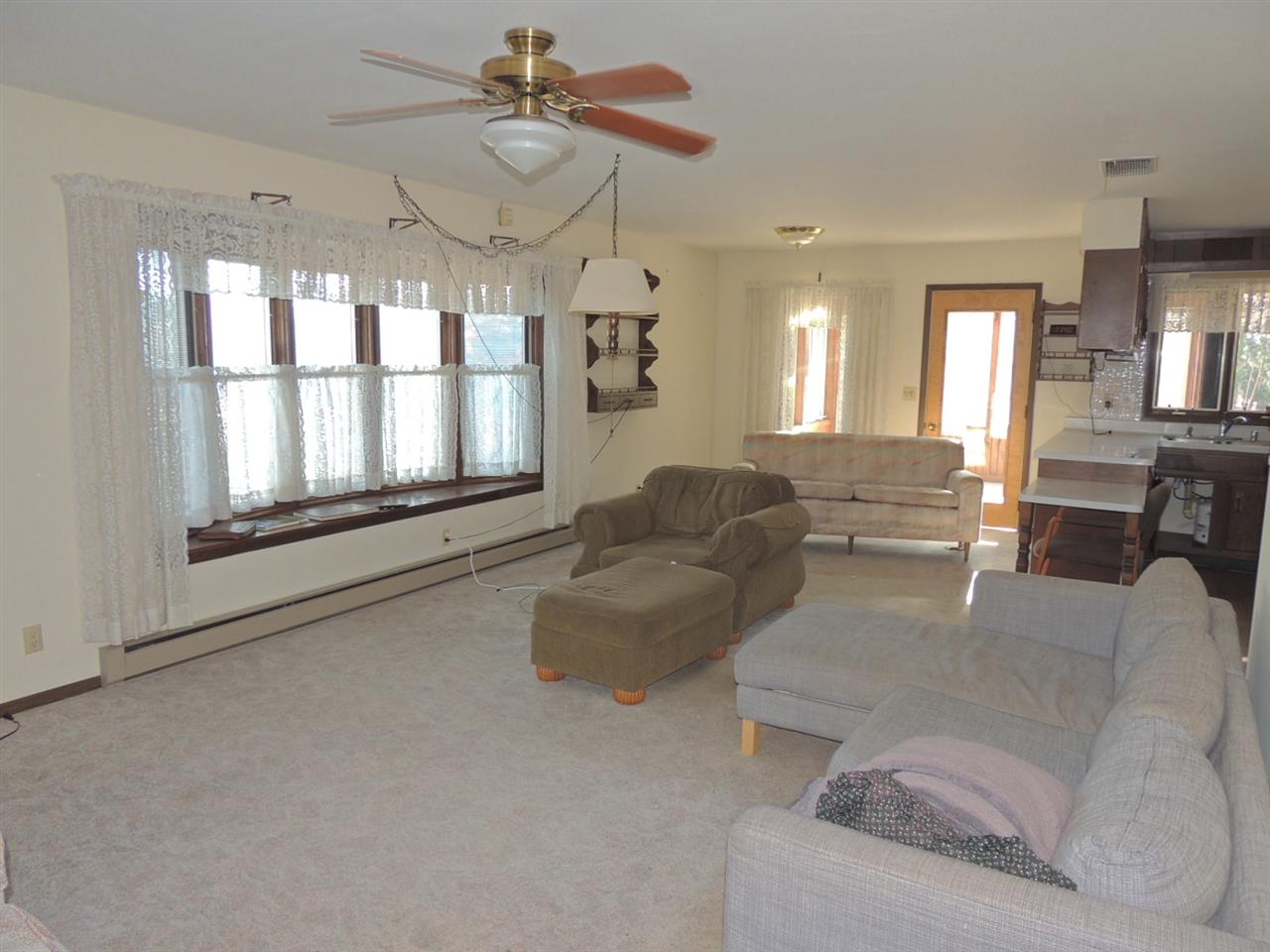 8344 South Schroeder Road Clinton, WI 53525 - Photo 4 of 25 a living room with furniture and a chandelier