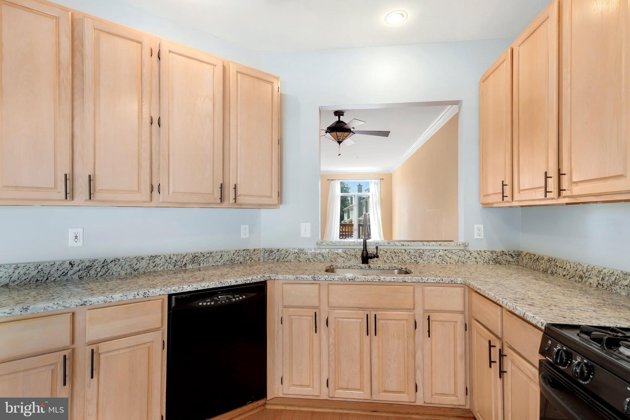 106 Lancefield Road Baltimore, MD 21209 - Photo 13 of 37 a kitchen with granite countertop stainless steel appliances white cabinets and a sink