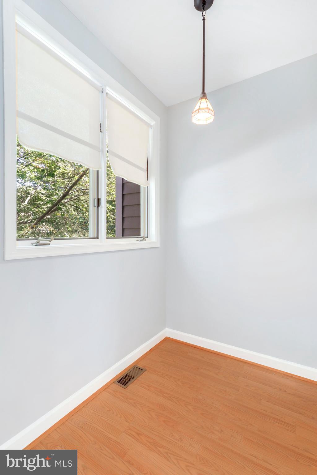 106 Lancefield Road Baltimore, MD 21209 - Photo 15 of 37 a view of empty room with wooden floor and fan