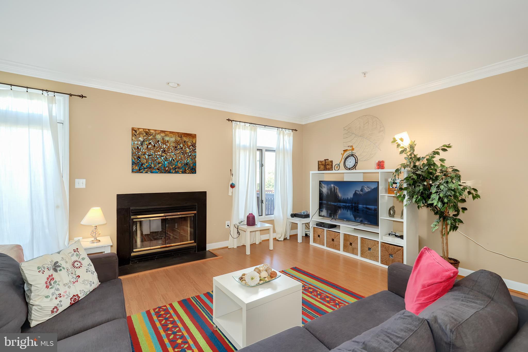 106 Lancefield Road Baltimore, MD 21209 - Photo 3 of 37 a living room with furniture a fireplace and a potted plant