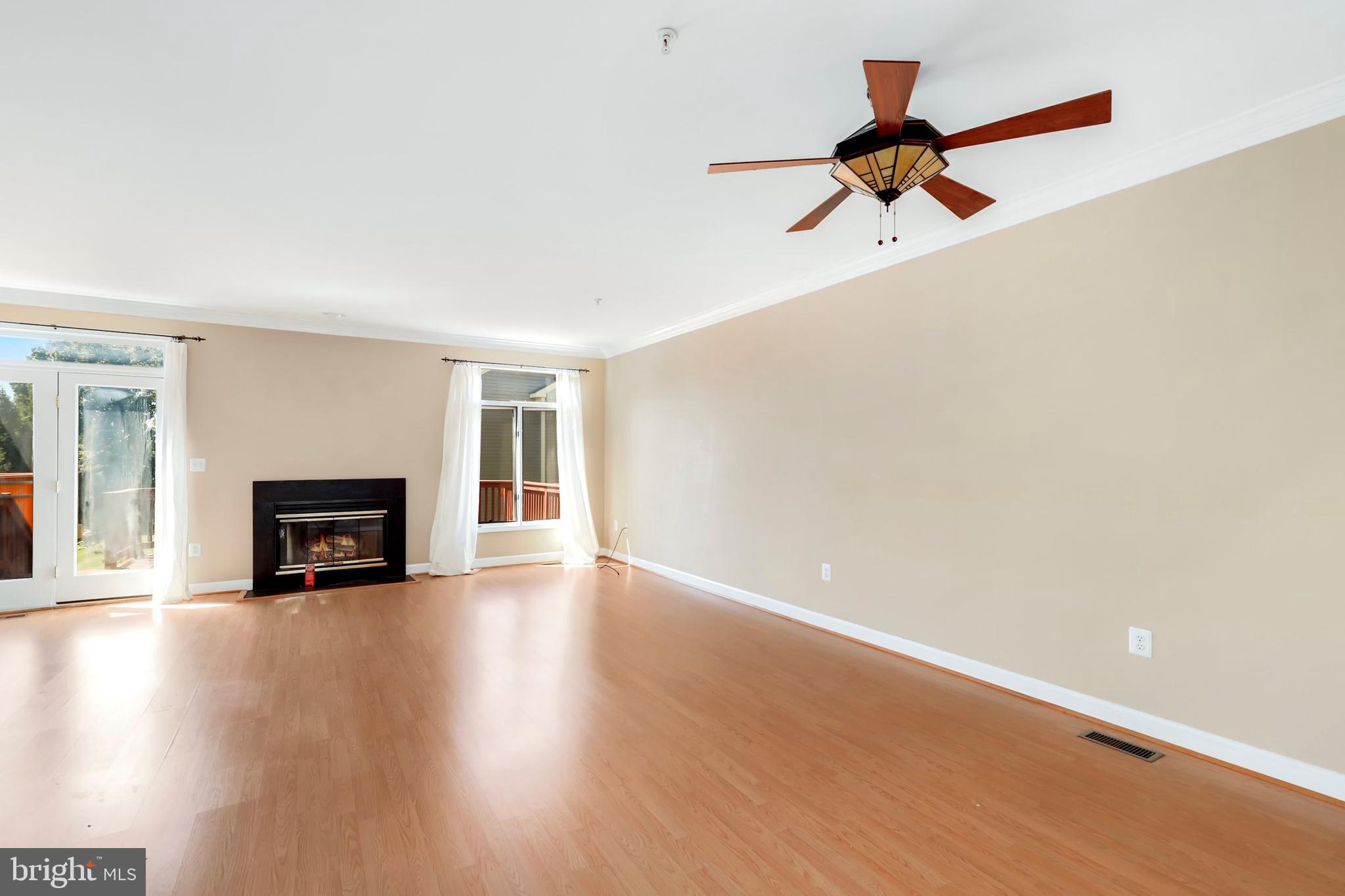106 Lancefield Road Baltimore, MD 21209 - Photo 4 of 37 a view of empty room with wooden floor and fireplace
