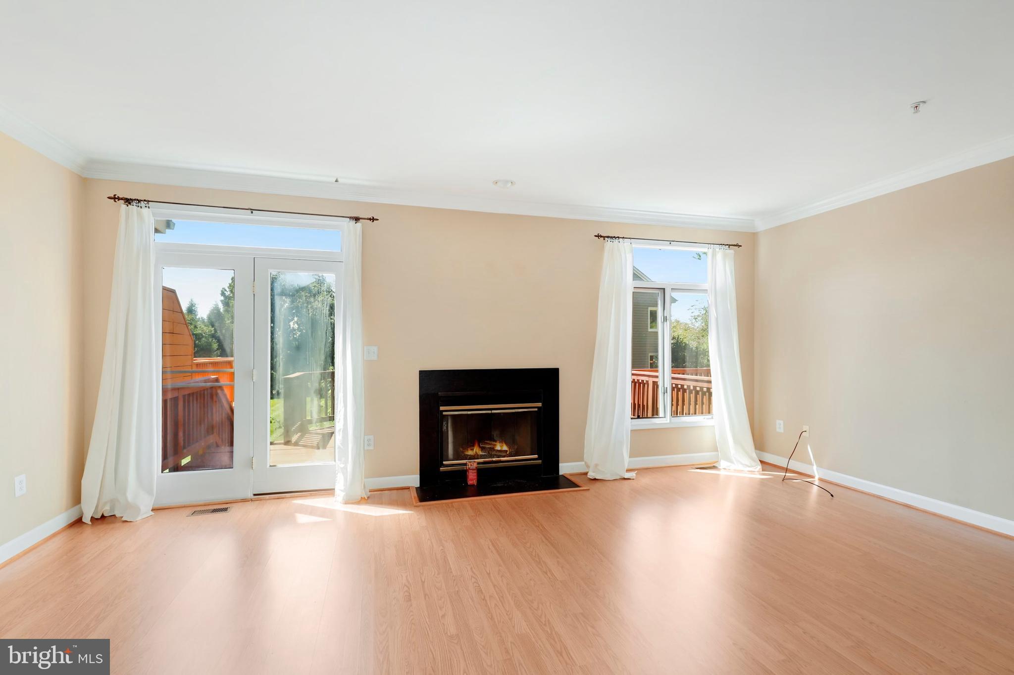 106 Lancefield Road Baltimore, MD 21209 - Photo 5 of 37 an empty room with windows and fireplace