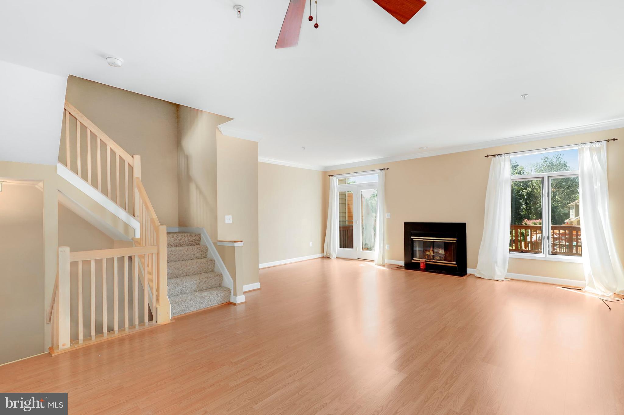 106 Lancefield Road Baltimore, MD 21209 - Photo 6 of 37 a view of an empty room with wooden floor and a window