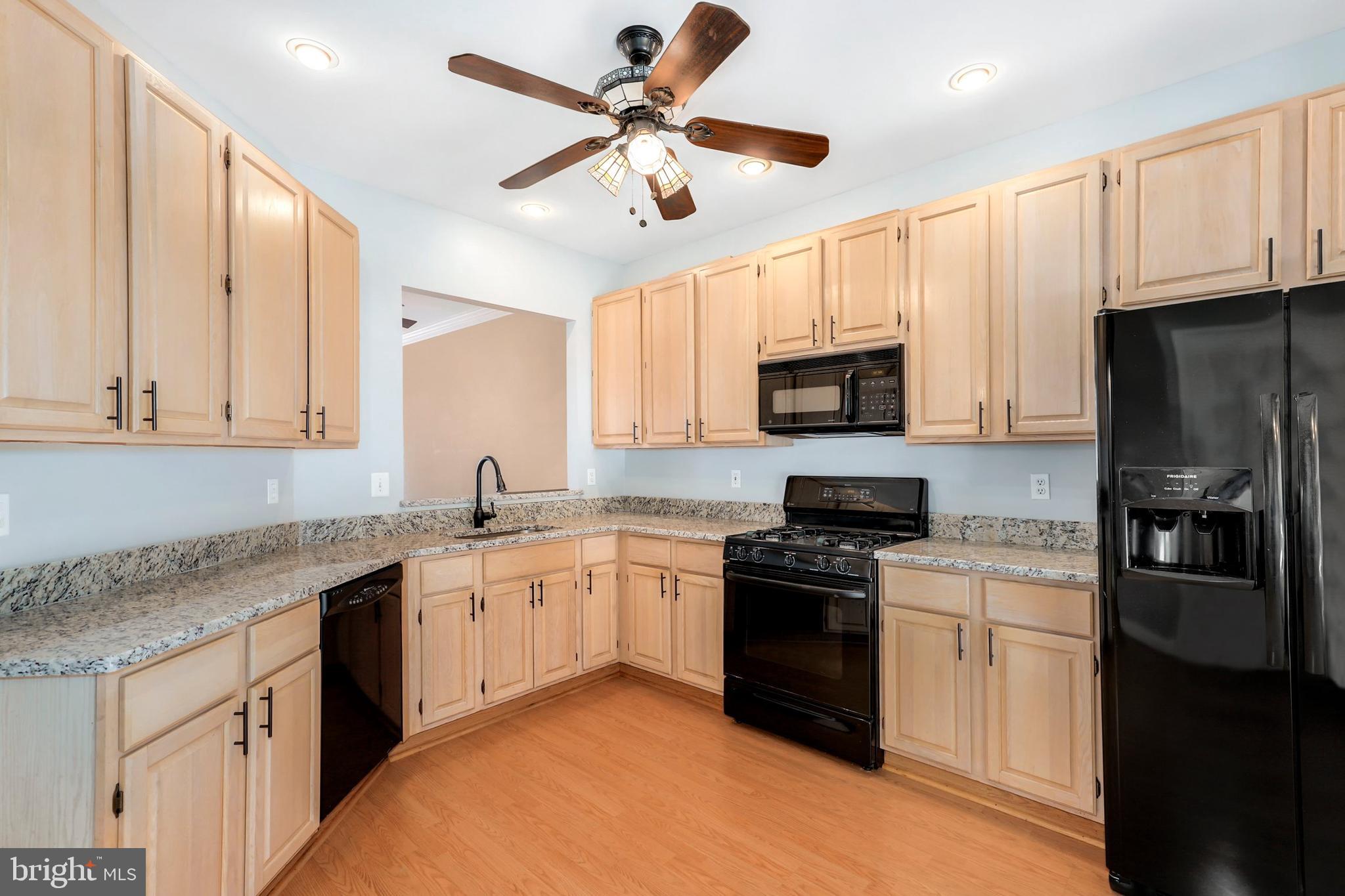 106 Lancefield Road Baltimore, MD 21209 - Photo 10 of 37 a kitchen with granite countertop a sink stainless steel appliances and cabinets