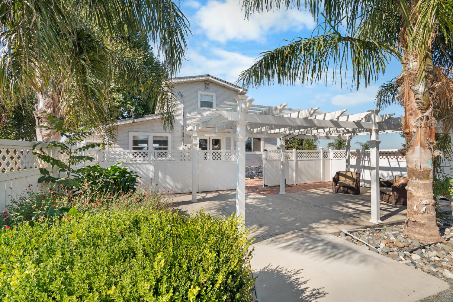a front view of a house with a garden