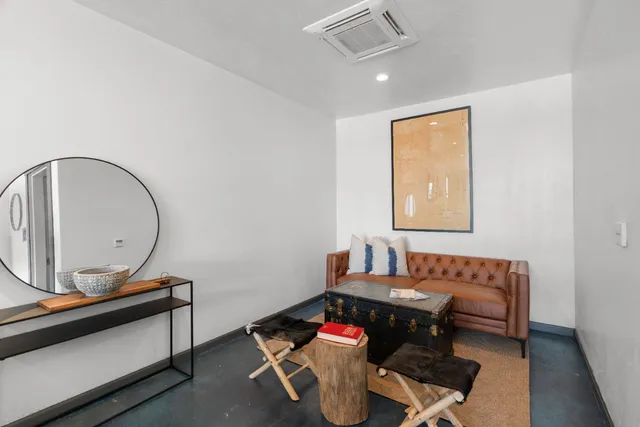 a white toilet sitting next to a bathroom sink