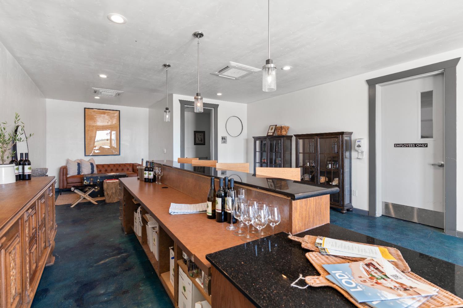6539 East Peltier Road Acampo, CA 95220 - Photo 19 of 70 an open kitchen with granite countertop a sink dishwasher a dining table and chairs with wooden floor