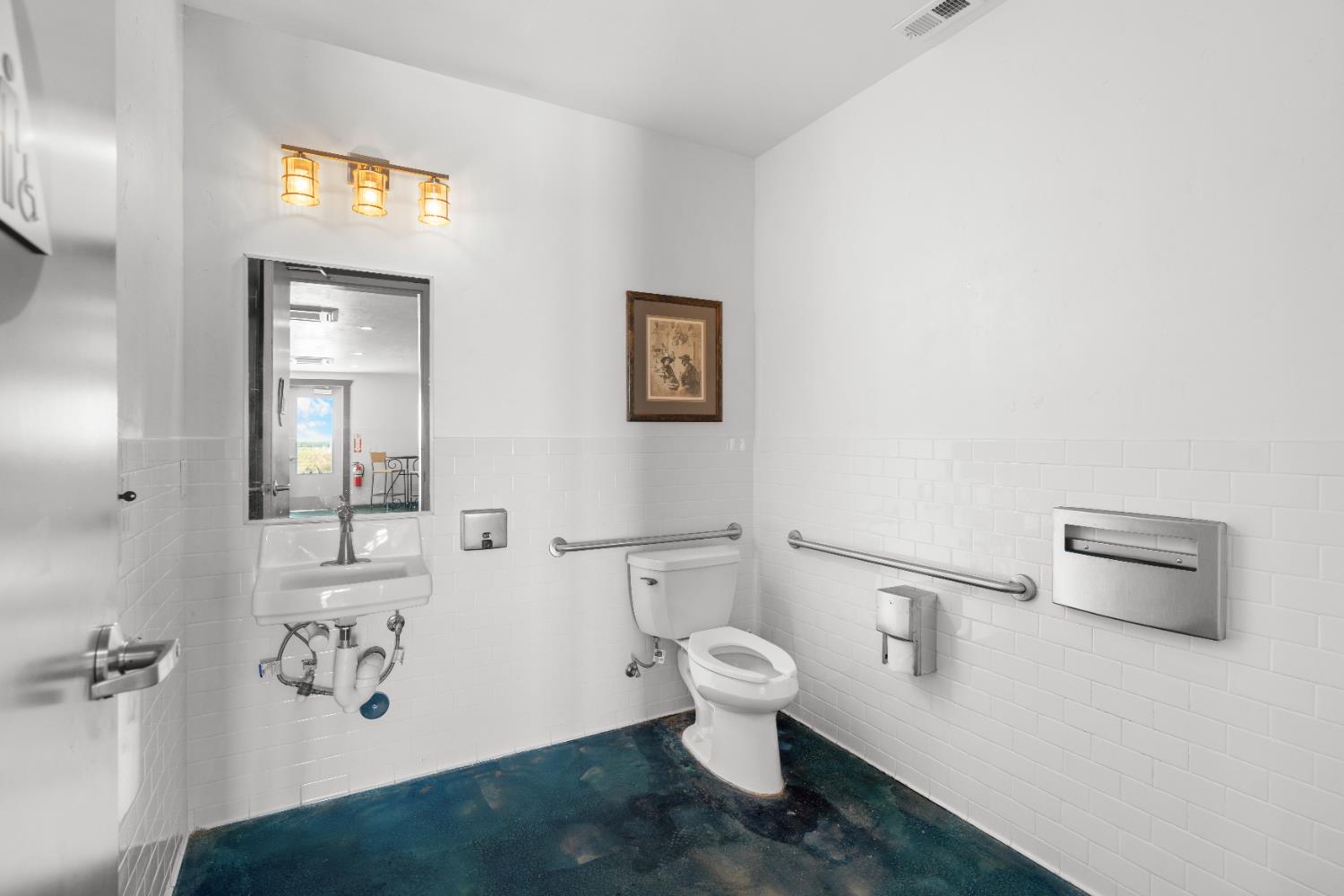 6539 East Peltier Road Acampo, CA 95220 - Photo 20 of 70 a white toilet sitting next to a bathroom sink