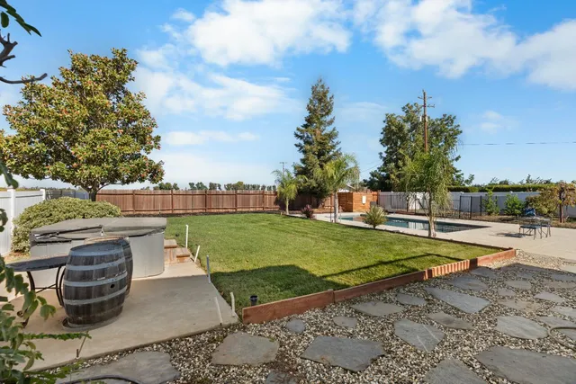 a swimming pool with outdoor seating and yard