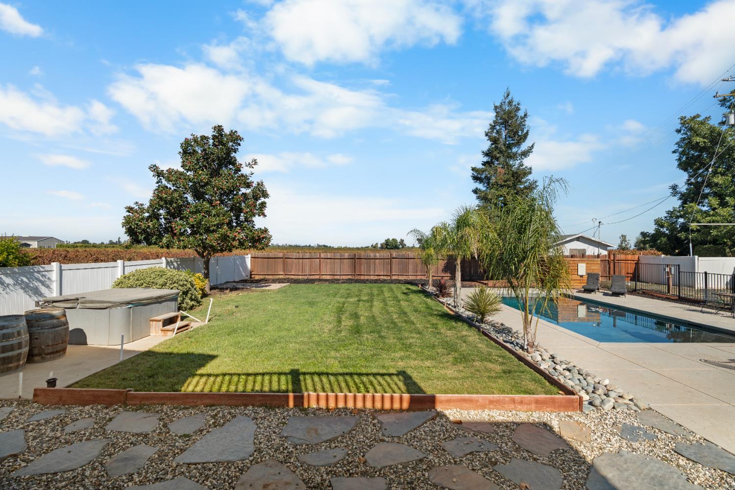 6539 East Peltier Road Acampo, CA 95220 - Photo 25 of 70 a view of a swimming pool with a yard