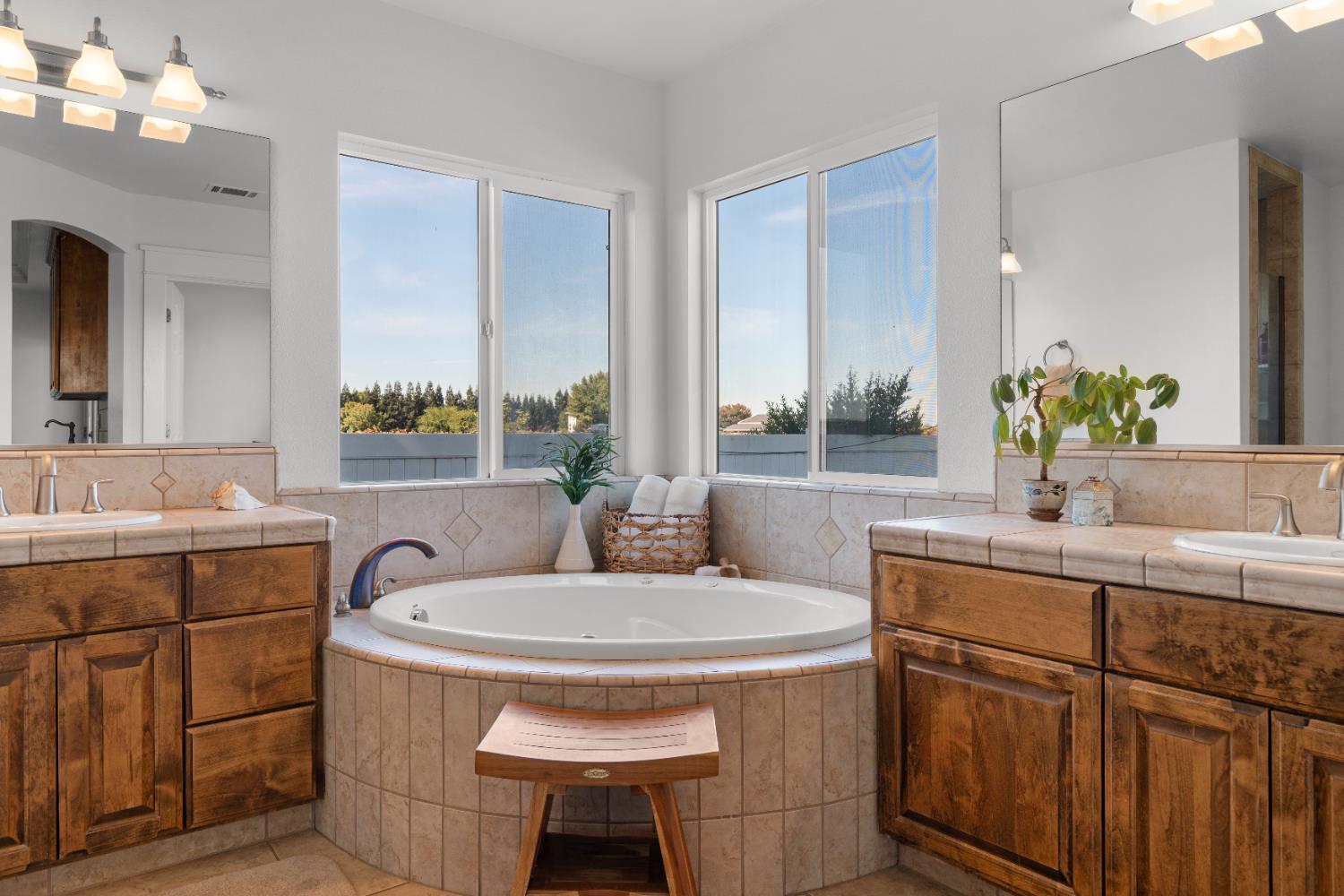 6539 East Peltier Road Acampo, CA 95220 - Photo 44 of 70 a bathroom with a sink double vanity and a mirror