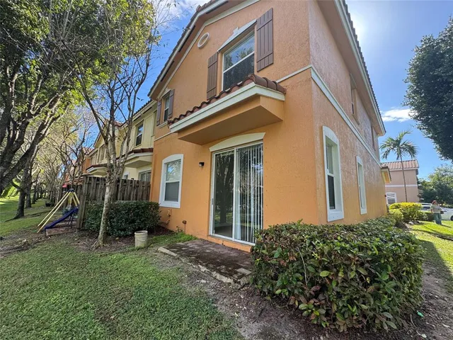 a view of a house with a yard and plants