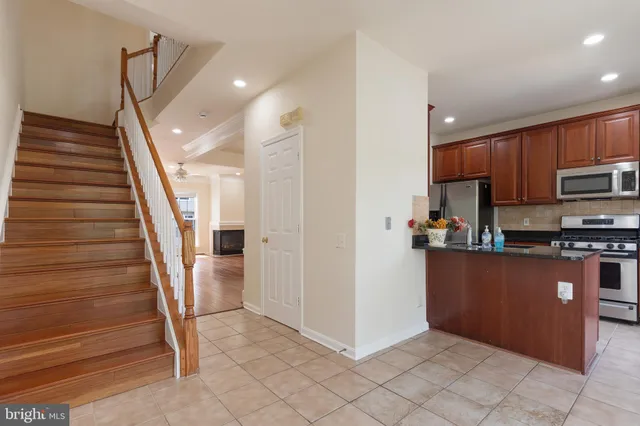a view of kitchen with microwave and cabinets