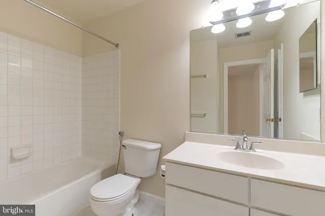 a bathroom with a sink toilet vanity and shower