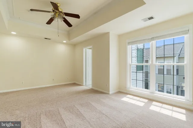 a view of empty room with ceiling fan