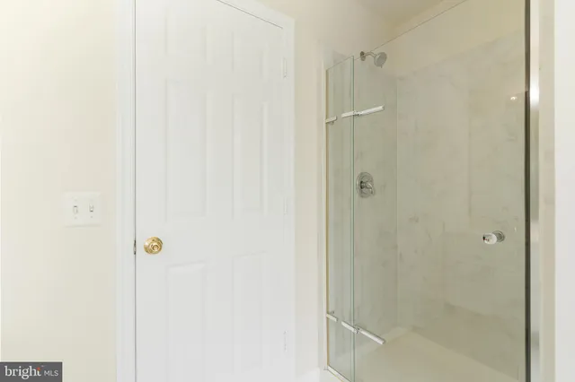 a bathroom with a glass shower door