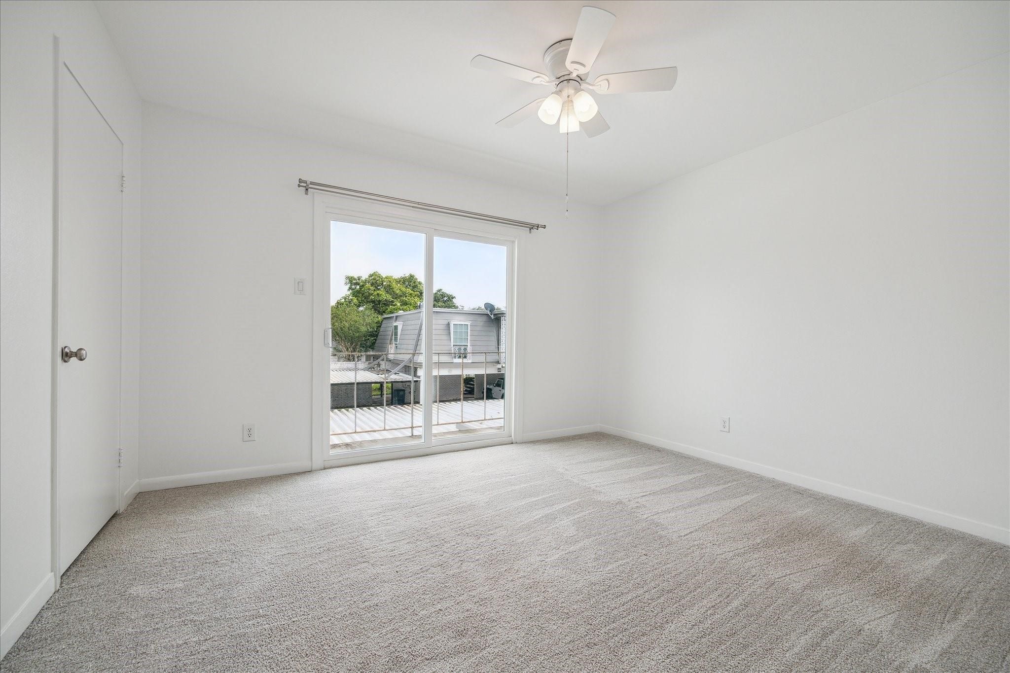 7821 Rue St Cyr Street, Unit 55 Houston, TX 77074 - Photo 7 of 16 Generously sized secondary bedroom with balcony access.