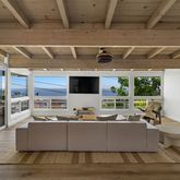 a living room with large window and a fireplace