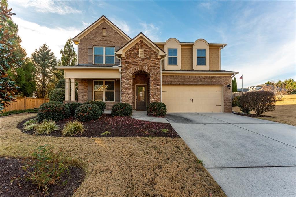 a front view of a house with a yard
