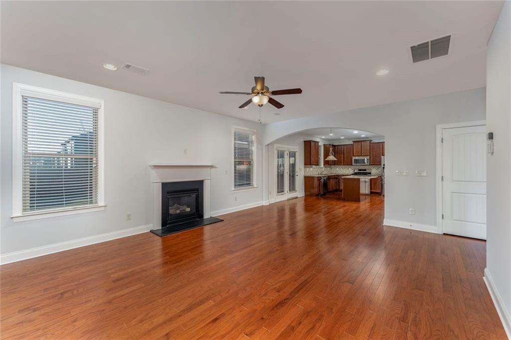 624 East Hampton Place Canton, GA 30115 - Photo 11 of 37 a view of an empty room with wooden floor fireplace and a window
