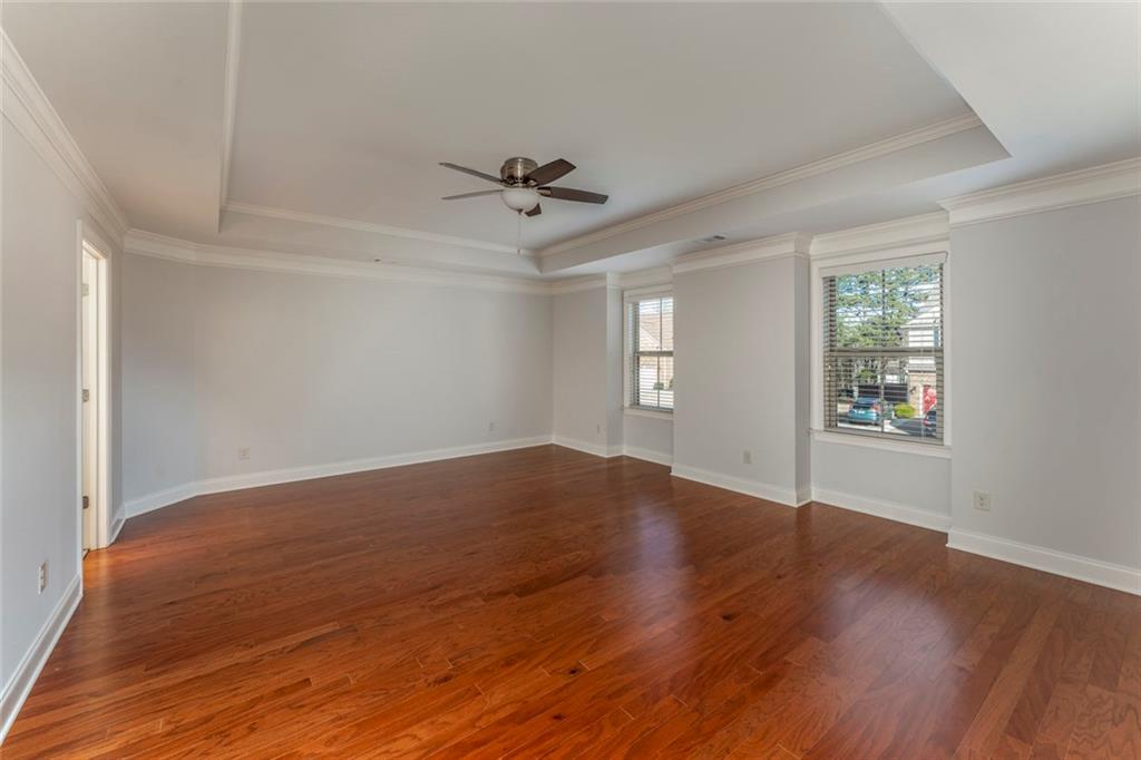 624 East Hampton Place Canton, GA 30115 - Photo 17 of 37 a view of empty room with wooden floor and fan