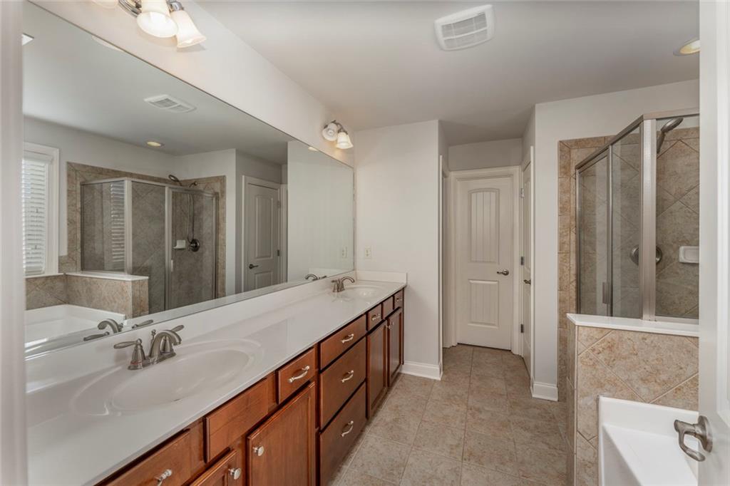 624 East Hampton Place Canton, GA 30115 - Photo 18 of 37 a spacious bathroom with a double vanity sink and a mirror
