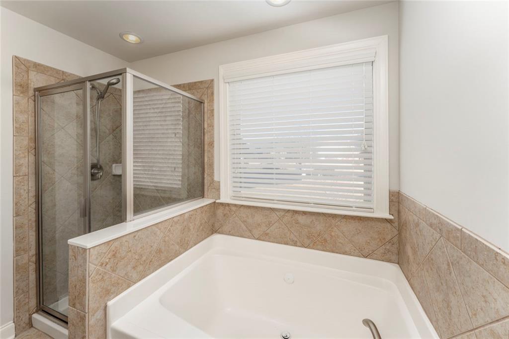 624 East Hampton Place Canton, GA 30115 - Photo 19 of 37 a white bath tub sitting in a bathroom