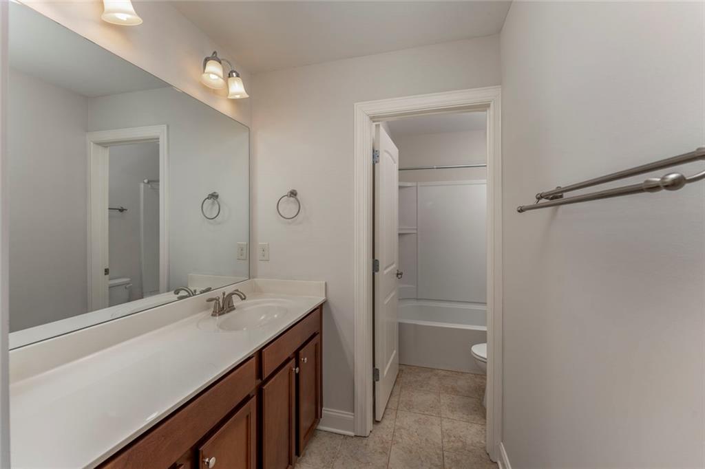 624 East Hampton Place Canton, GA 30115 - Photo 22 of 37 a bathroom with a sink a toilet and shower