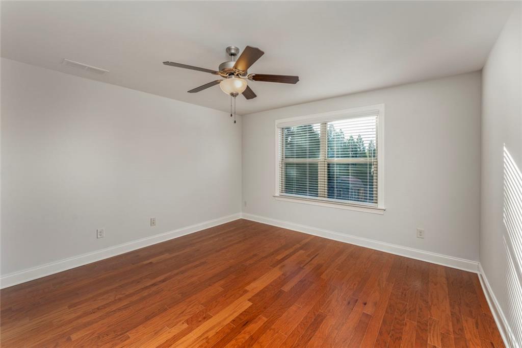 624 East Hampton Place Canton, GA 30115 - Photo 23 of 37 a view of an empty room with wooden floor and a window