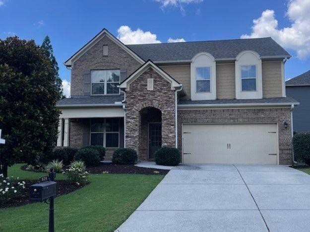 624 East Hampton Place Canton, GA 30115 - Photo 36 of 37 a front view of a house with a garden