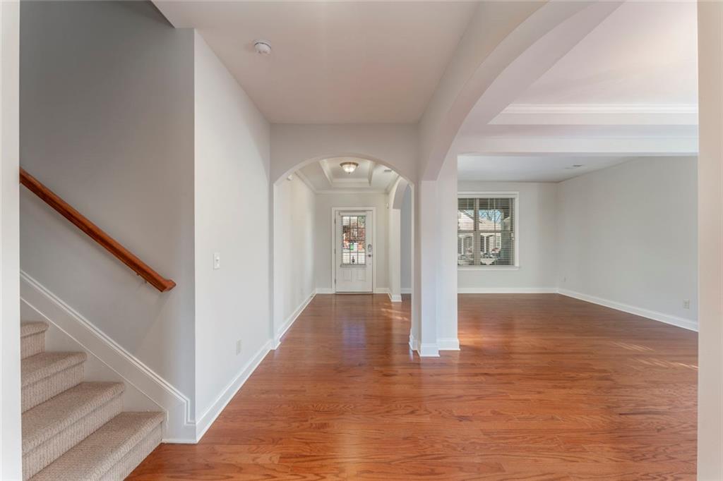 624 East Hampton Place Canton, GA 30115 - Photo 6 of 37 a view of an empty room with wooden floor and a window