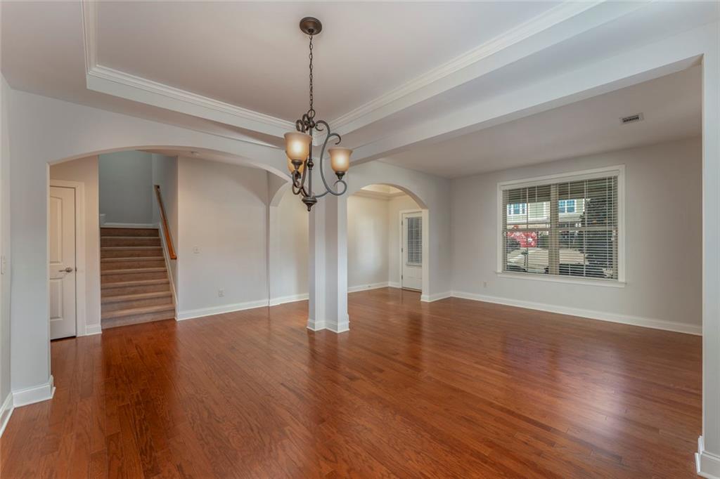 624 East Hampton Place Canton, GA 30115 - Photo 7 of 37 a view of an empty room with wooden floor and a window