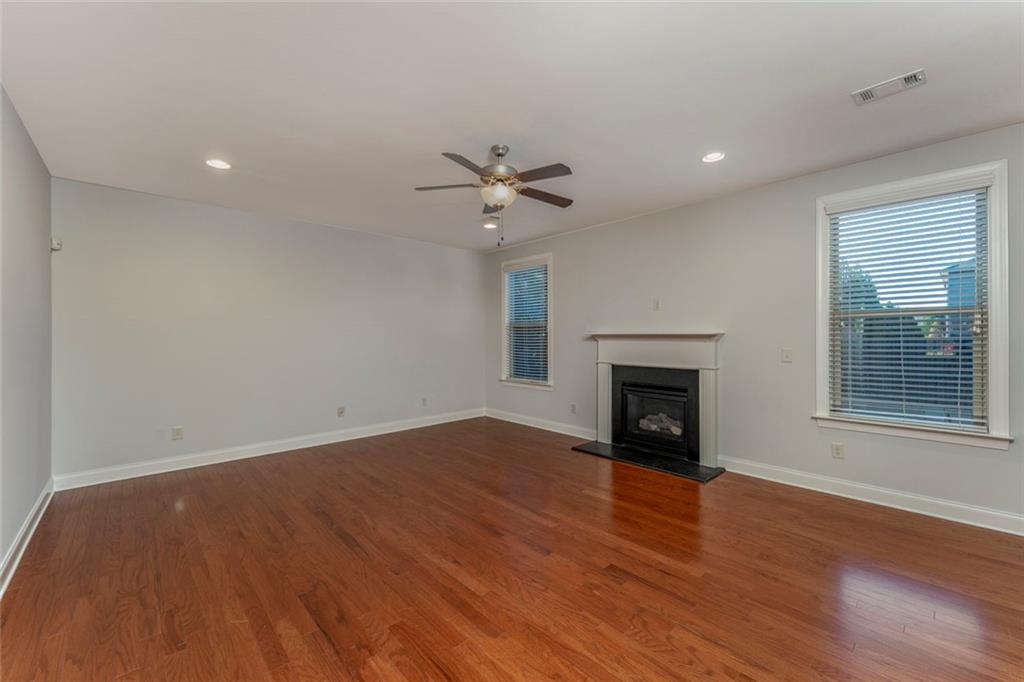 624 East Hampton Place Canton, GA 30115 - Photo 10 of 37 an empty room with fan and fireplace