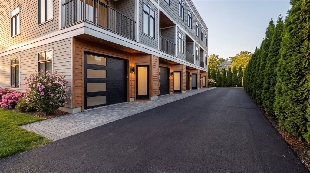 15 Tanglewood Road, Unit D Boston, MA 02126 - Photo 2 of 28 a view of a building with a yard