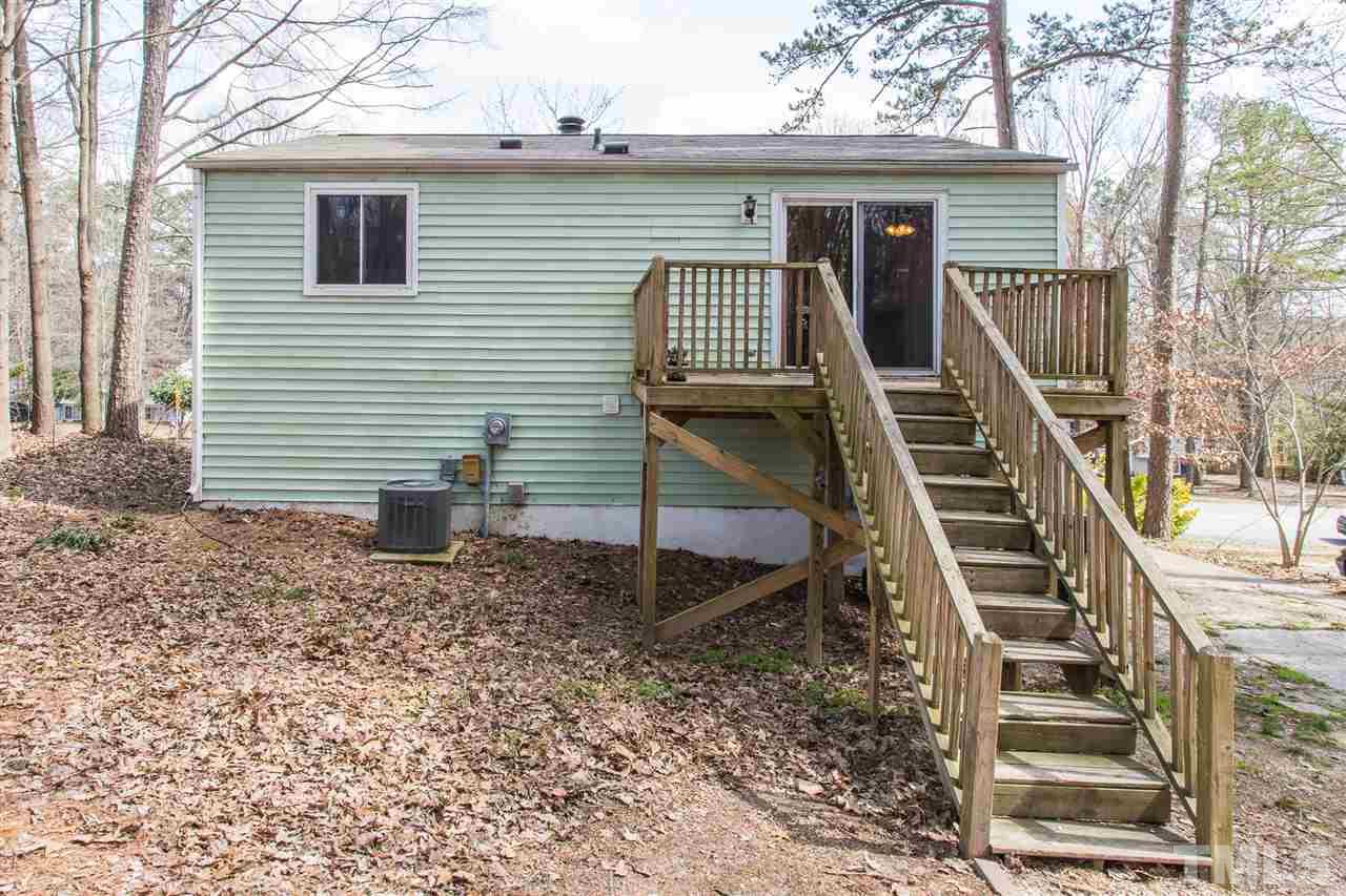 8005 Mourning Dove Road Raleigh, NC 27615 - Photo 20 of 22 A sunny deck off the kitchen welcomes you into the low maintenance backyard.